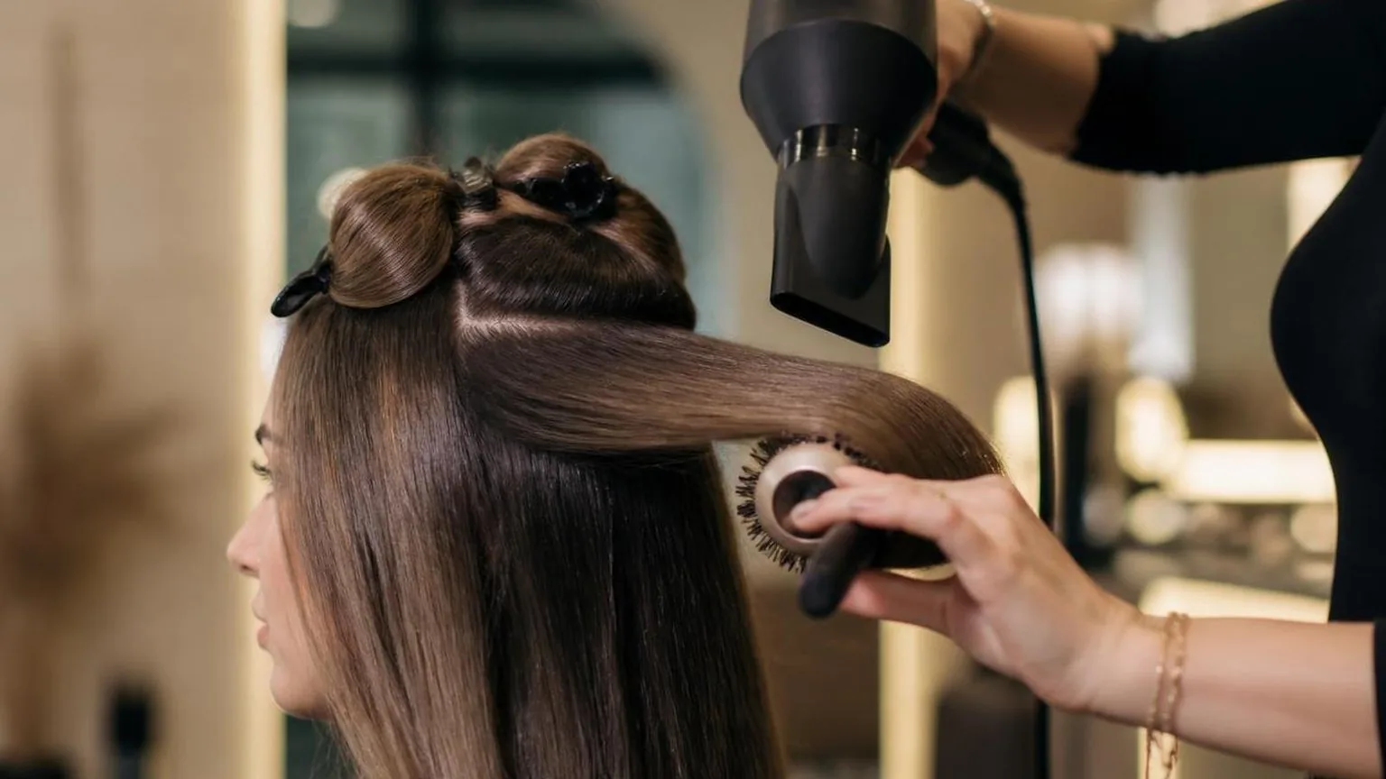 A salon reception desk with the day's appointment book open, during a real blow dry