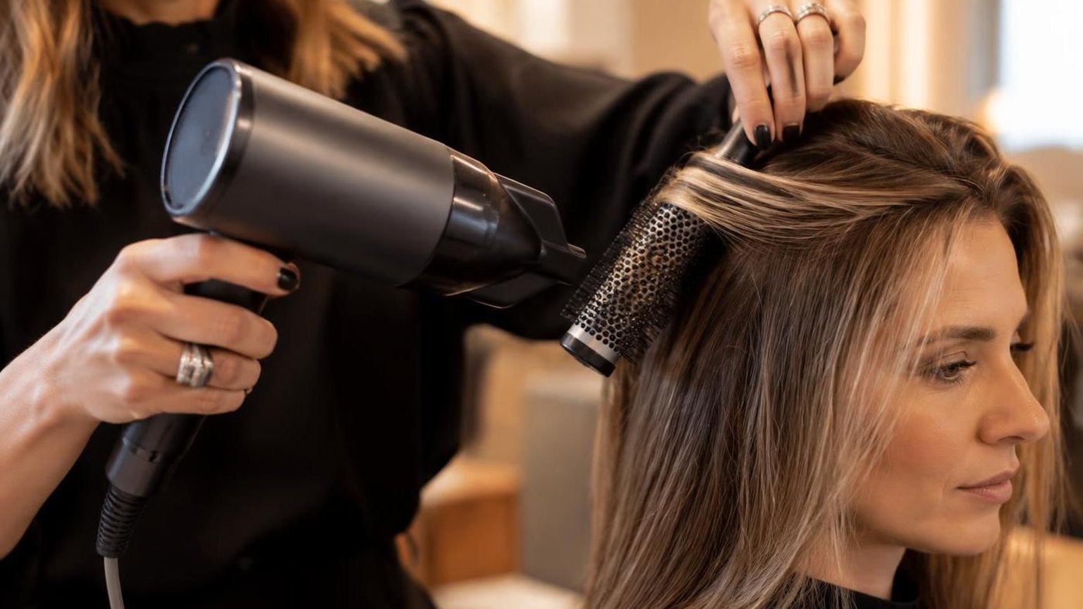 Clips holding sections apart on damp hair, overhead view, in a working salon