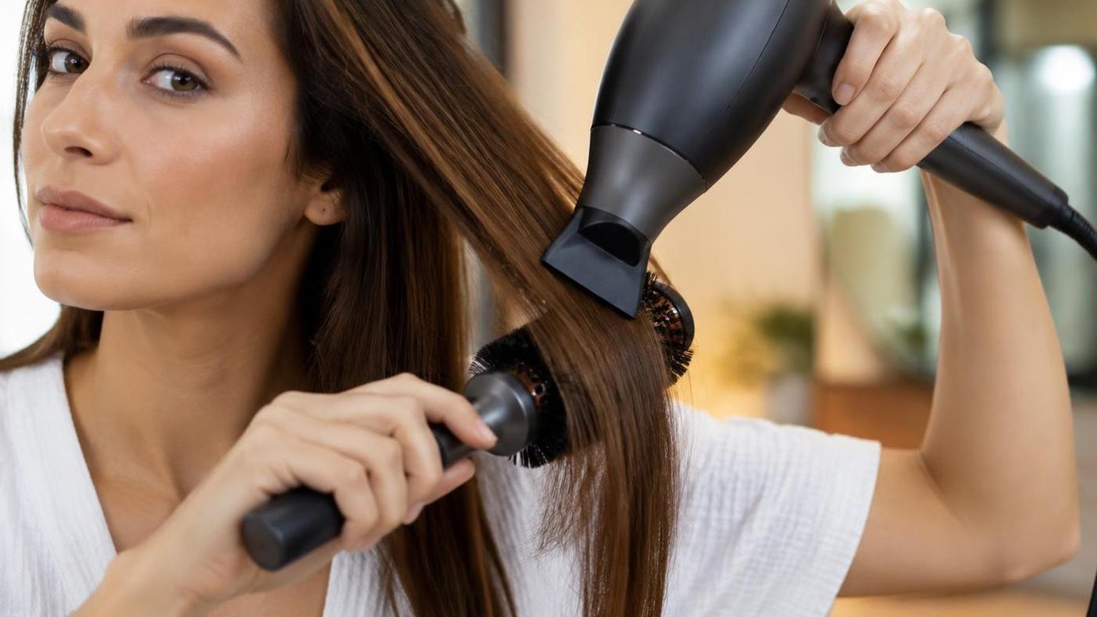The workstation mid-service, tools in use and hair in motion, in a working salon