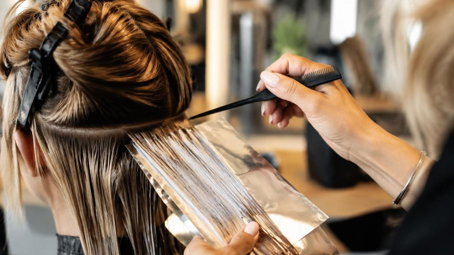 A salon reception desk with the day's appointment book open, shown close up